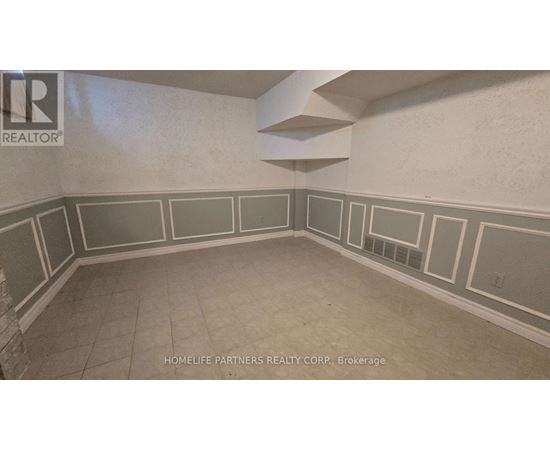 A room with a wall that has a border of squares and rectangles.