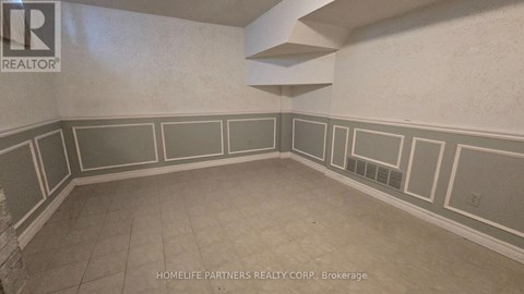A room with a wall that has a border of squares and rectangles.