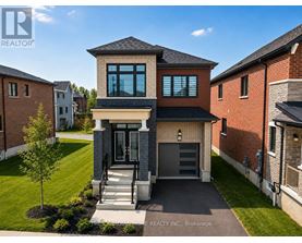 A modern house with a brick facade and a large front yard.