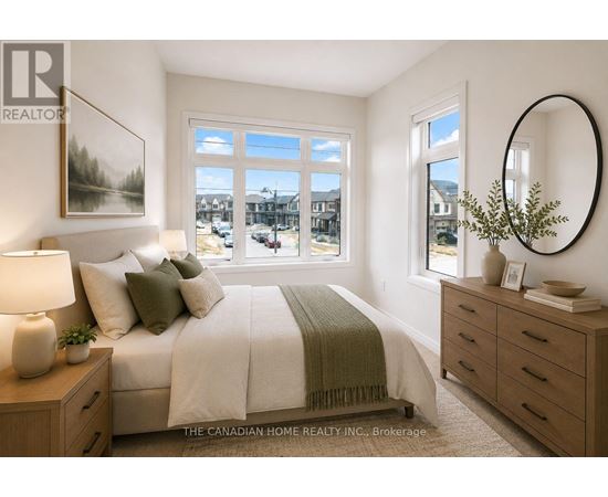 A bedroom with a large bed, a nightstand with a lamp, and a round mirror on the wall.