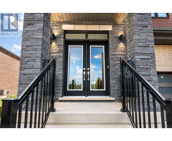 The entrance to a building with a glass door and a sign that reads "The Canadian Home Realty Inc. Brokerage."