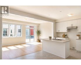 A white kitchen with a large island in the middle.