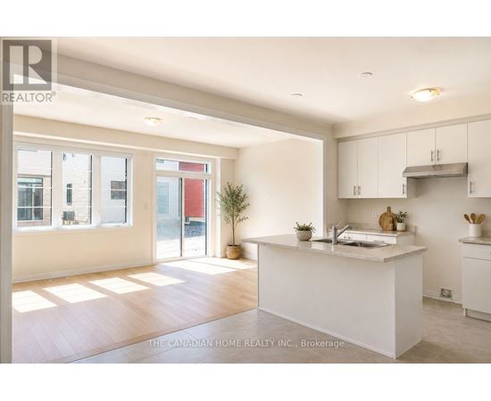 A white kitchen with a large island in the middle.