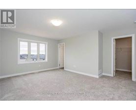 A room with a window and a door is available for rent.
