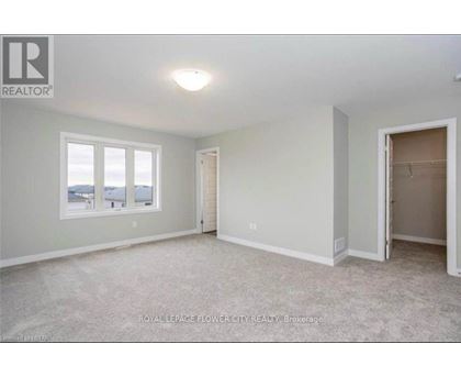 A room with a window and a door is available for rent.