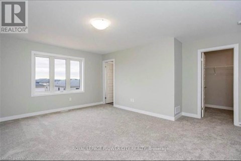 A room with a window and a door is available for rent.