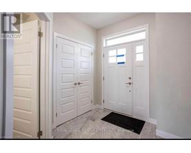 A white door with a black mat in front of it.