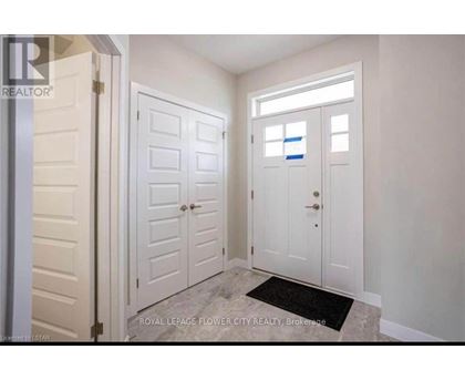 A white door with a black mat in front of it.