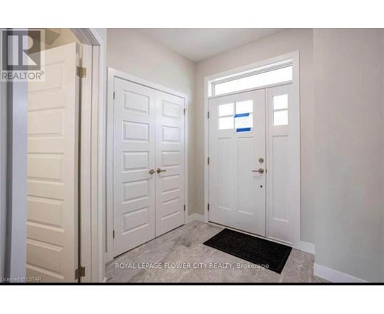 A white door with a black mat in front of it.