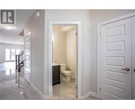 A white bathroom with a toilet and sink.