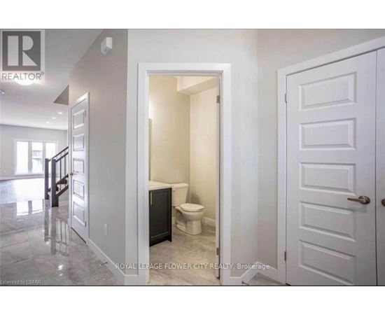 A white bathroom with a toilet and sink.
