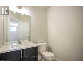 A white bathroom with a toilet and sink.