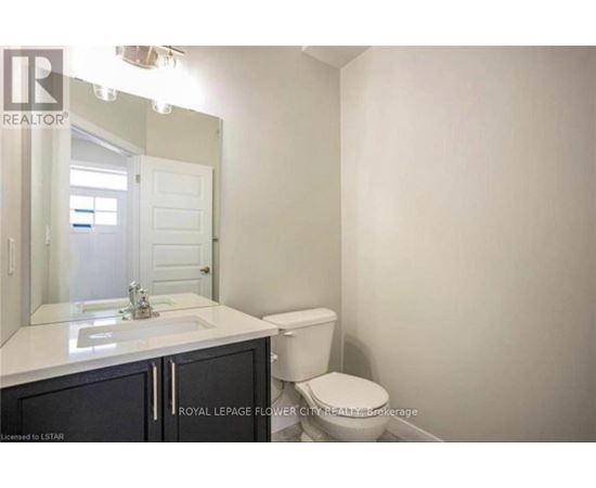 A white bathroom with a toilet and sink.