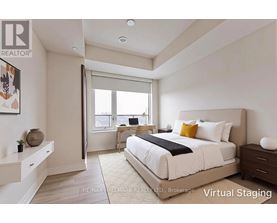 A bedroom with a large bed and a desk with a chair.