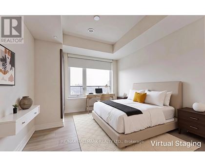 A bedroom with a large bed and a desk with a chair.