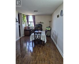 A dining room with a table set for two.