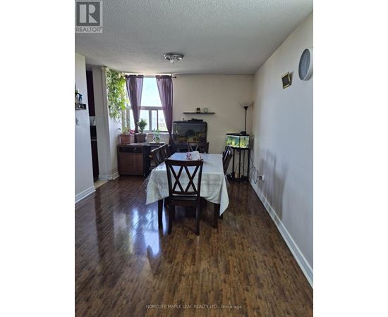 A dining room with a table set for two.