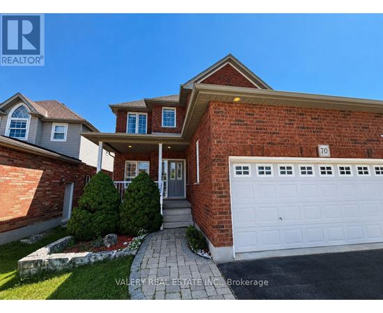 A house with a brick wall and a white garage door is for sale.