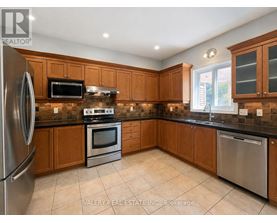 A kitchen with wooden cabinets and stainless steel appliances.