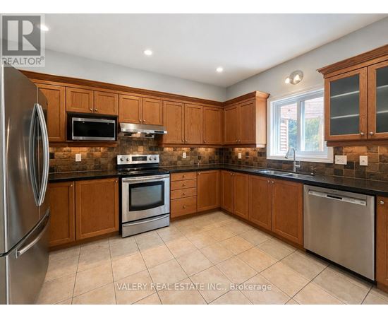A kitchen with wooden cabinets and stainless steel appliances.