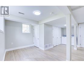 A spacious room with a washer and dryer in it.