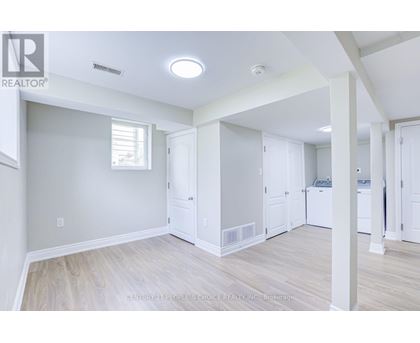 A spacious room with a washer and dryer in it.