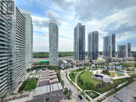 A view of a city with tall buildings and a green park area.