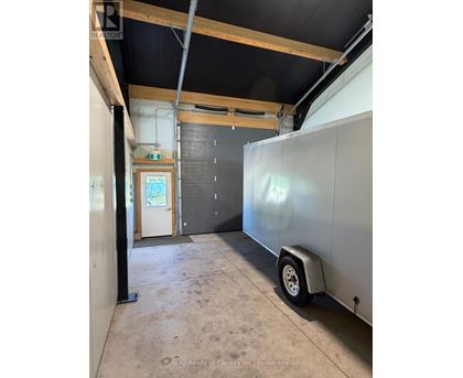 A large, empty room with a trailer in it.