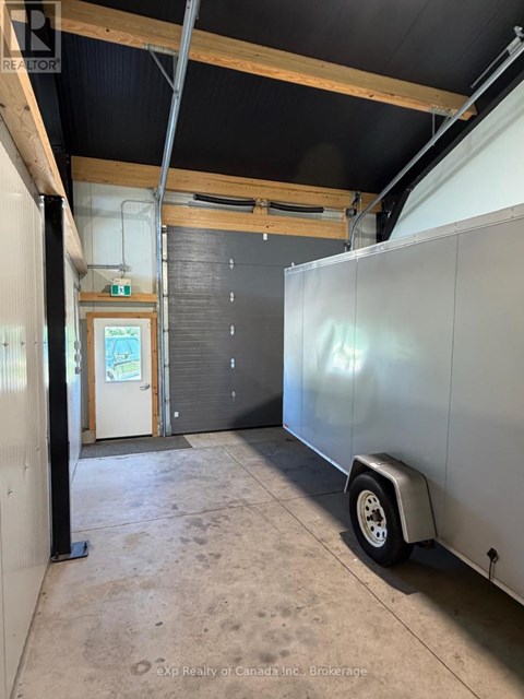 A large, empty room with a trailer in it.