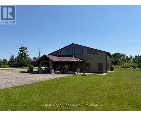 A building with a brown roof and a sign that says REALTOR in the upper left corner.