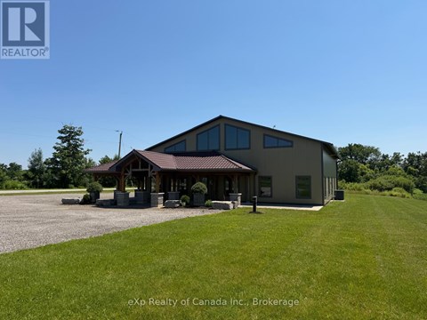 A building with a brown roof and a sign that says REALTOR in the upper left corner.