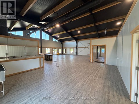 A large open space with wooden floors and exposed ceiling beams.