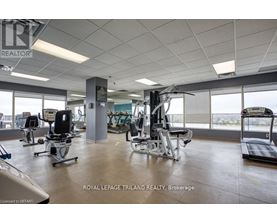 A gym with a variety of equipment including treadmills, weights, and exercise machines.