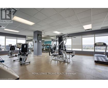 A gym with a variety of equipment including treadmills, weights, and exercise machines.
