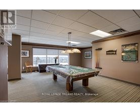 A room with a pool table and a chair.