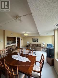 A living room with a wooden table and chairs.