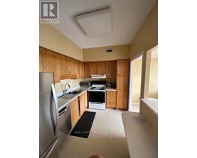 A kitchen with wooden cabinets and stainless steel appliances.