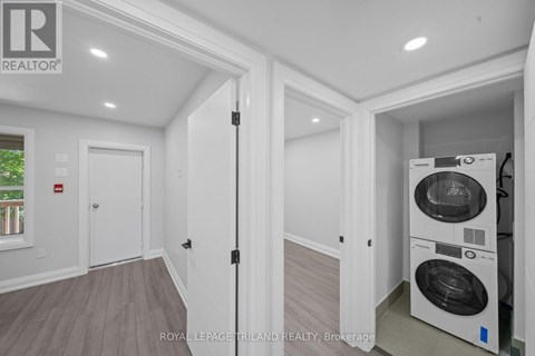 A white laundry room with a washer and dryer.
