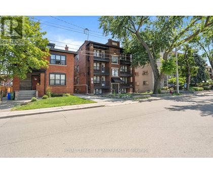A street view of a residential area with apartment buildings.