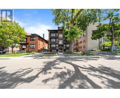 A sunny day in a residential area with a mix of modern and traditional buildings.