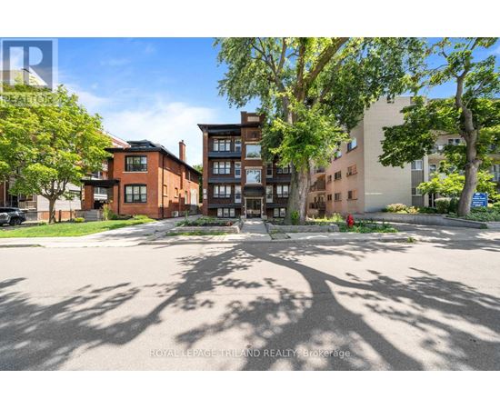 A sunny day in a residential area with a mix of modern and traditional buildings.