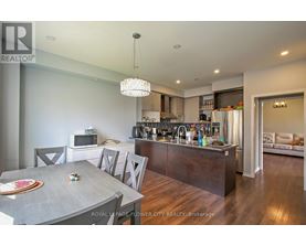 A modern kitchen with a dining table and chairs.