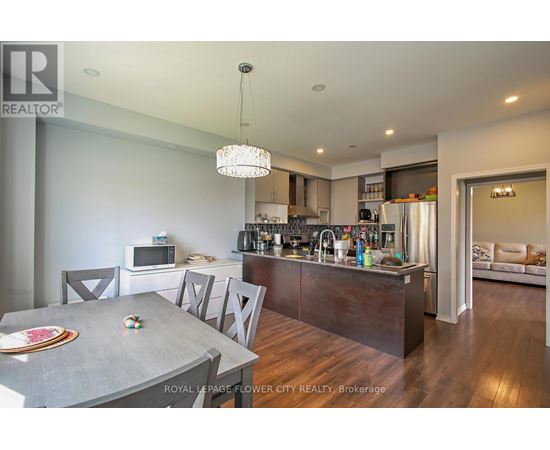 A modern kitchen with a dining table and chairs.