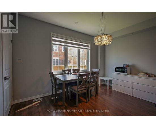 A dining room with a table and chairs.