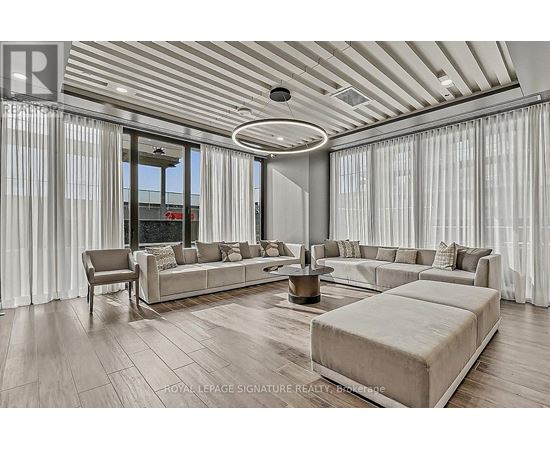 A spacious living room with a large sectional sofa and a coffee table.
