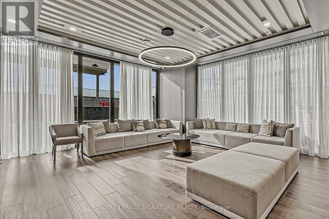 A spacious living room with a large sectional sofa and a coffee table.