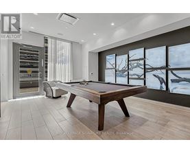 A pool table in a room with a view of a snowy landscape outside the window.