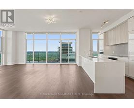 A spacious, empty room with a view of the cityscape through large windows.