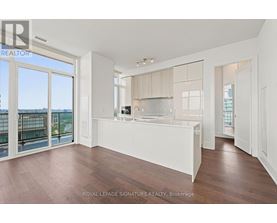 A spacious kitchen with white cabinets and a large island.