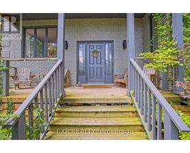 A house with a blue door and a wooden porch.